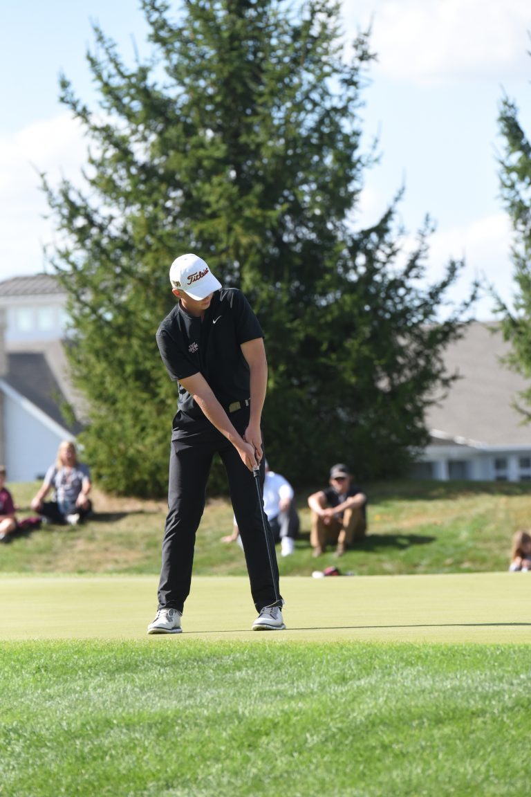 Kalida's Paul Stechschulte watches a putt roll towards the cup on the ninth green during the Division III state golf tournament.