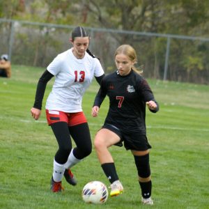Columbus Grove's Mia Verhoff (7) looks to advance the soccer ball against this Delphos Jefferson player during their Division V district final Thursday. (CherryRoad Media/Brandon Unverferth)